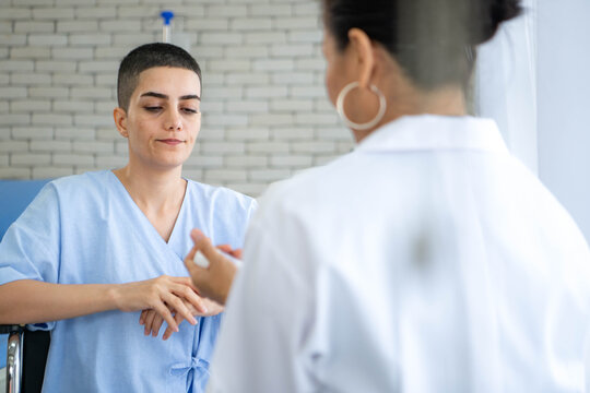 Female patient using inhaler under doctor supervision in hospital room