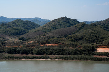 Rolling hill green forest river mountain landscape rural countryside natural scenery blue sky peaceful view daylight outdoor nature Rolling hill and green forest reflect calm river blue sky