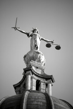 Lady of Justice of the Central Criminal Court fondly known as the Old Bailey in the city of London  England UK, monochrome black and white scales of justice, stock photo image