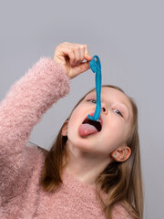 Teen girl holding blue gummy candy near her mouth in studio, sweet snack concept, candy craving, playful lifestyle, sugary treat