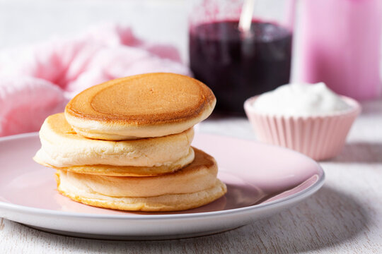 Fluffy pancakes, Japanese souffle pancakes served with cream and currant jelly.