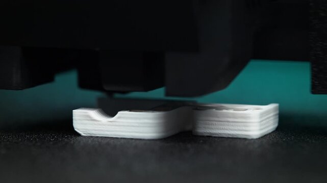 3D Print Created From White Thermoplastic Filament Extruded From The Nozzle of an FDM 3D Printer in Macro