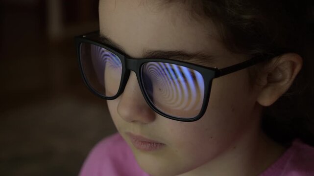 Child Girl With Glasses Watching Hypnotic Screen. Influence of Media on People. Broadcast False Information, Hoax, Propaganda Brainwashing Disinformation. Manipulation Crowd Fakes, False Information.