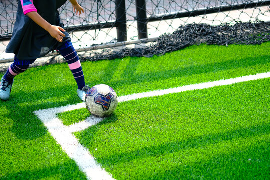 Young boy taking corner kick during youth soccer match.