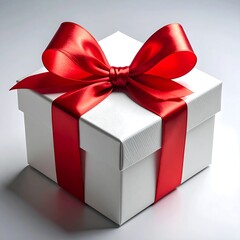 Fototapeta premium A pristine white square gift box is adorned with a large, vibrant red satin bow and matching ribbon, elegantly tied