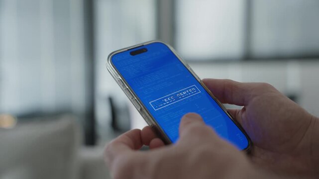 Close up on person holding smart phone as device is hacked and blocked. Man receives notification warning of cyber security attack on private phone. Glitch screen message appear. Malware virus attempt