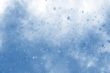 Bright blue sky with scattered white clouds seen from below.