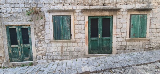 Medieval stone house with green doors and windows, Risan, near Perast, Montenegro 