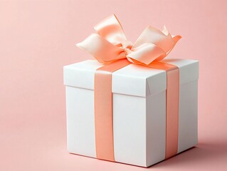 Obraz premium Elegant white gift box with coral ribbon on soft pink background