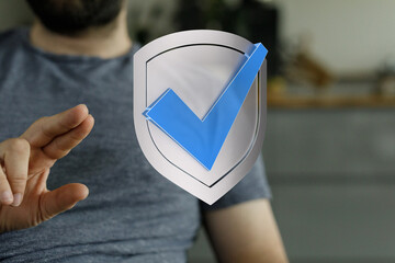 Concept of approval, security, and assurance with hand interacting with a shield and checkmark....