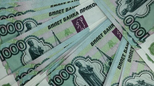 Macro shot of numerous Russian hundred-ruble bills and Bitcoin. The concept of financial security. Profit growth and abundance in the modern world.