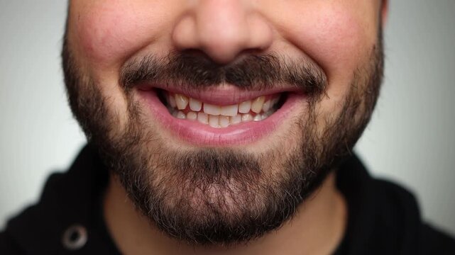 Close up of a strange and creepy smile. Man smiling creepy. Strange smile