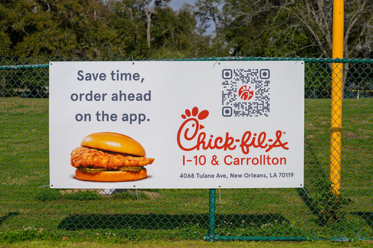 New Orleans, LA, USA - February 20, 2026: Closeup of Chick-fil-a Sign on an Outfield Fence at a Youth Baseball Park in Uptown Neighborhood