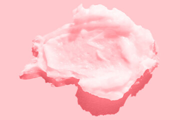 Pink creamy swirl on pastel background for skincare and beauty product promotion.