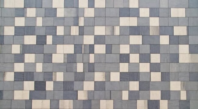 Abstract rectangular tile pattern with staggered blue grey and light beige colors creating subtle dimensional texture