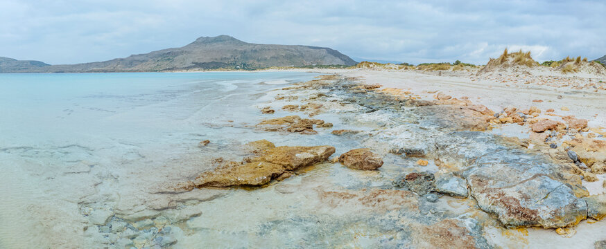 Simos Beach, Elafonisos, Greece: Rocky beach with turquoise water and distant mountain