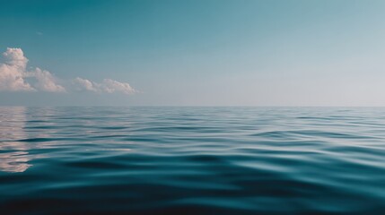 Fototapeta premium Calm ocean surface meets a clear sky above the distant horizon line