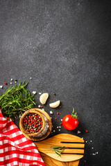 Kitchen table with herbs, spices and utensils.