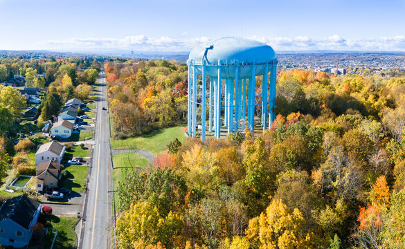 Aerial view of large municipal water tower on a sunny autumn day, Troy, NY, with view to the horizon beyond