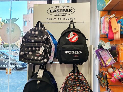 Rome, Italy - February 20, 2025, a series of Eastpak backpacks, an American brand specializing in bags, backpacks, travel items, and accessories, displayed for sale in a stationery shop.