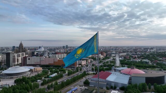 Kazakhstan flag waving in the wind overlooking the city of astana