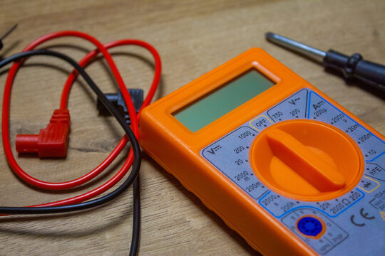 Digital multimeter with wires, tool for battery voltage checking