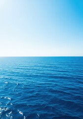 Obraz premium A sweeping view of the deep blue ocean water meeting the horizon on a clear, sunny day, emphasizing the massive scale of the water body, travel, clear, aquatic