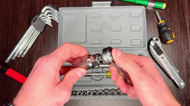 Close-up. Male hands select a head from a set of hand tools and put it on a wrench. Perfect video for DIY, home repair, maintenance and professional repair.