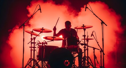 Energetic drummer silhouette performing on a red stage