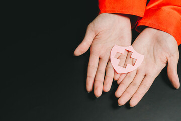 life insurance concept. Health protection shield hands human hand safety security orange sleeve black background care symbol medical health care protection concept person