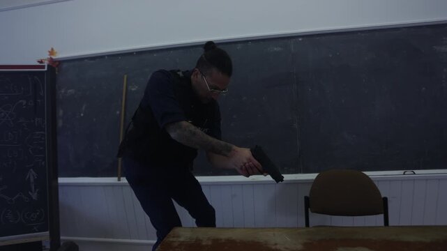 Officer with weapon drawn checks under desk