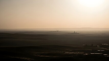 Obraz premium A hazy landscape with a bright sun in the background