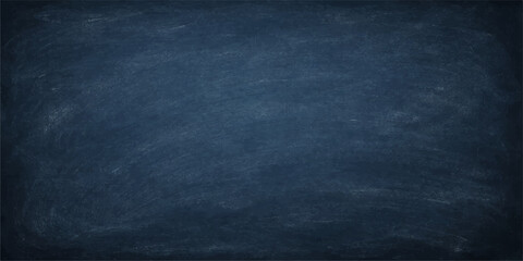 A dark blue chalk board with a grunge textured surface and vintage denim canvas pattern creates a rough blue wallpaper backdrop © PAGLAA