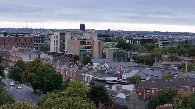 Aerial drone view of Rathmines, Dublin, Ireland summer evening. Scenic rooftops, residential buildings, and city skyline captured from above, with a LUAS tram moving through the streets