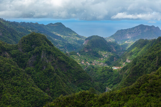 Aerial view over a green valley with lush Laurissilva vegetation in the mountains of the isle of Madeira