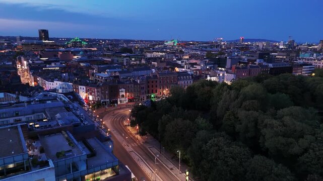 Aerial drone shot over  Dublin, Ireland St. Stephen&rsquo;s Green park at sunset, Vibrant city life with glowing shopping malls