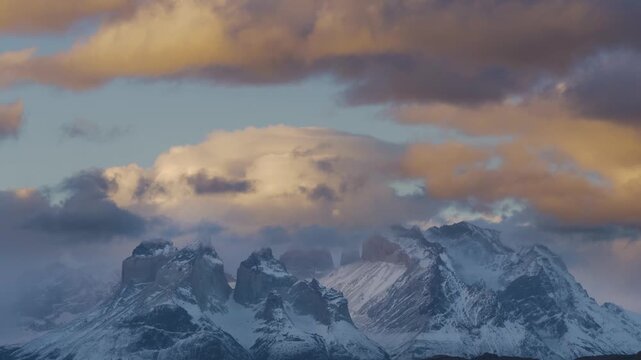 4K video, Timelapse video of clouds moving over the snow covered Paine mountain range at sunset, Patagonia Chile