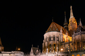 Fisherman's Bastion in Budapest illuminated at night. The historic structure features turrets and arches, surrounded by a quiet plaza. © VasylisaDvoichenkova