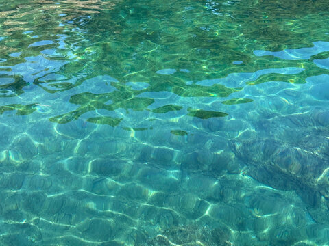 Green clear sea water surface.