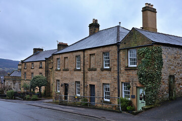 Historic buildings on South Church Street in Bakewell, Derbyshire  historic village street in the Peak District with traditional English architecture, stone houses, quaint cottages with climbing plant © Cissa King