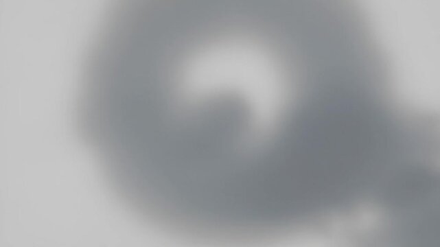 Abstract image of swirling grey gradient pattern with soft and blurred texture