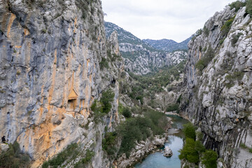 Located on the historic St Paul Trail in Antalya, the Gavurevi rock tomb features unique Roman architecture and rare hunter reliefs overlooking the Eurymedon River.