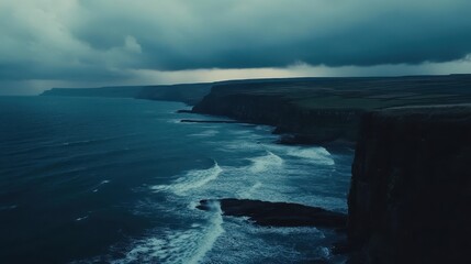 Dramatic ocean waves crash against rugged cliffs under a dark, moody, stormy sky