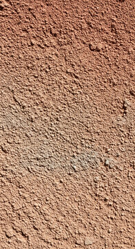 Close-up of granular brown surface, creating rough, textured appearance, symbolizing natural, earthy material, perfect for industrial or construction themes