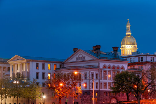 Illuminated NJ state capitol complex with golden dome at night in Trenton, New Jersey, USA