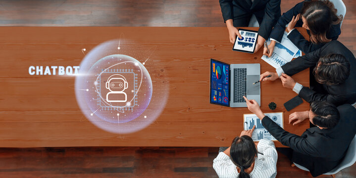 A diverse team collaborates in a modern office, focused on developing chatbot technology. Digital interfaces showcase data analysis and visualizations. Trope