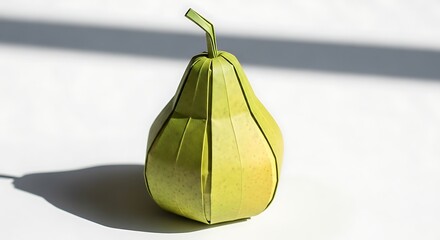 Paper origami green pear model on white surface