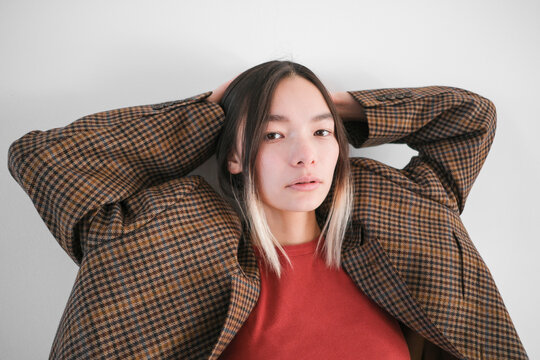 Portrait of a young woman in an oversized checkered blazer 