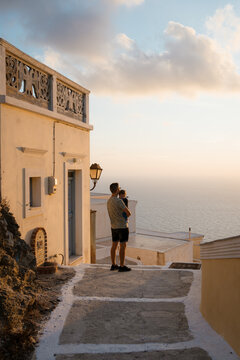 Man and son during a walk in a town at sunset