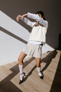 Stylish woman dancing in studio